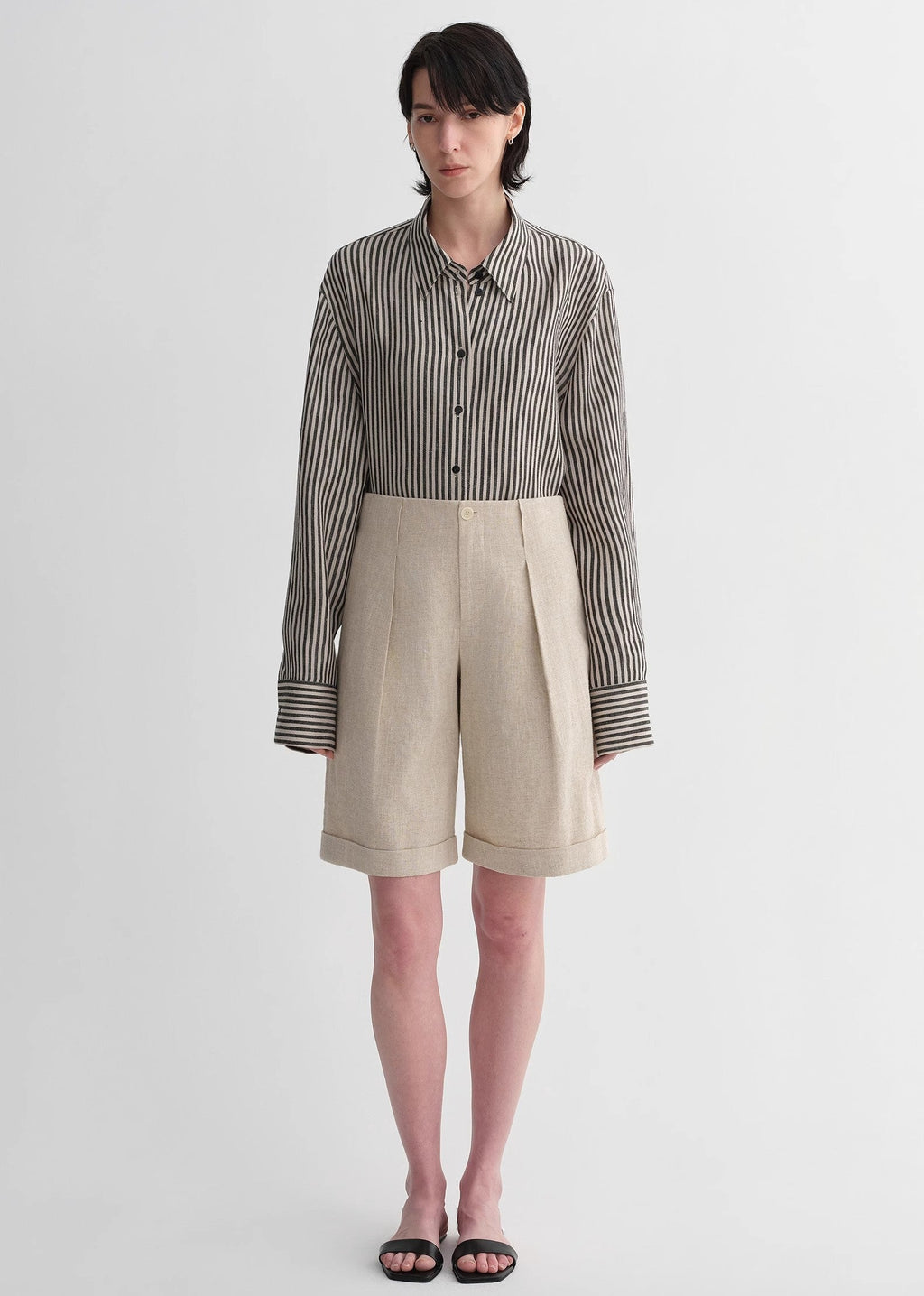 Sophisticated linen waistless pleated wide-leg cropped pants for women, featuring architectural silhouette, textured side pockets