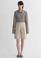 Sophisticated linen waistless pleated wide-leg cropped pants for women, featuring architectural silhouette, textured side pockets