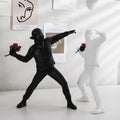 ArtZ® Man Throwing Flowers Sculpture - Set of 2 (1 White and 1 Black)
