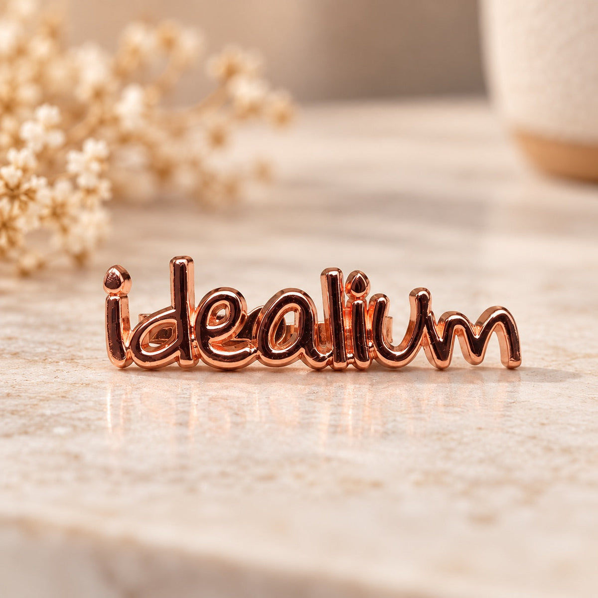 Logo metálico Idealium para bolsos – Oro rosa