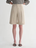 Sophisticated linen waistless pleated wide-leg cropped pants for women, featuring architectural silhouette, textured side pockets