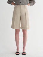 Sophisticated linen waistless pleated wide-leg cropped pants for women, featuring architectural silhouette, textured side pockets