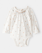 Body de manga larga floral con cuello de volantes en algodón