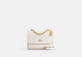 COACH® Women's Bolso cruzado Klare de lona de firma en Blanco | Pvc