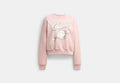 COACH® Women's Jersey De Cuello Rojoondo Con Gráfico De Caramelo en Rosa, Talla Mediano
