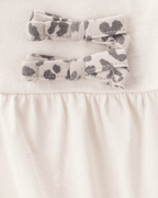 Conjunto 2 piezas con body de lazos y pantalón leopardo