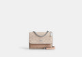 COACH® Women's Minibolso cruzado Klare de lona de firma en Beige | Pvc