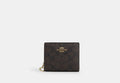 COACH® Women's Cartera con botón automático de lona de firma en Beige | Pvc