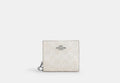 COACH® Women's Cartera con botón automático de lona de firma en Blanco | Pvc