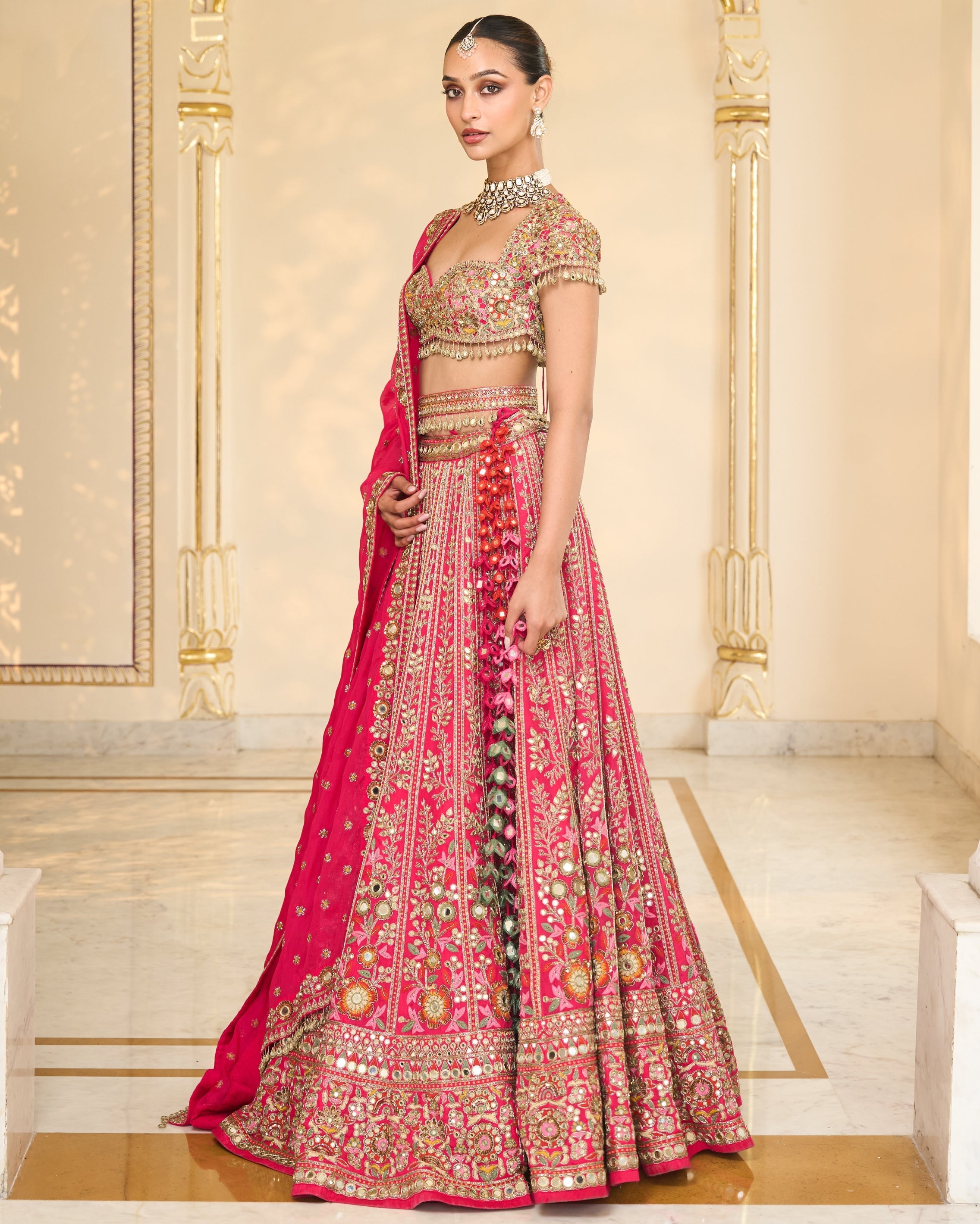 Rani Pink Organza Multicolour Thread And Mirror Hand Embroidered Lehenga Set By KYNAH, Luxury Indian Fashion & Bridal Wear
