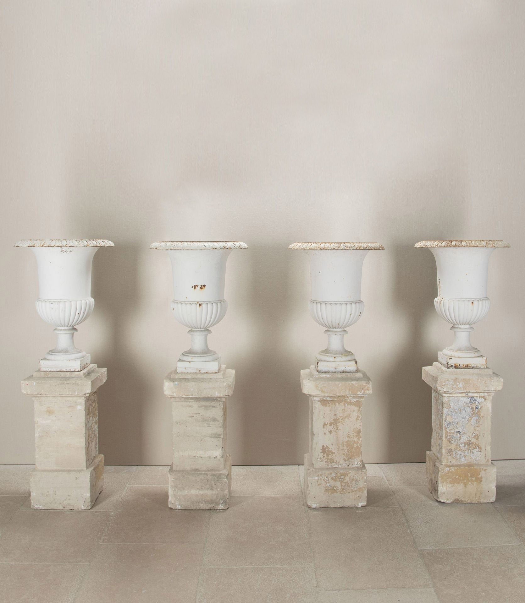 Set of Four 19th Century French Cast Iron Urns on 19th C Stone Plinths By Sister Parish Design